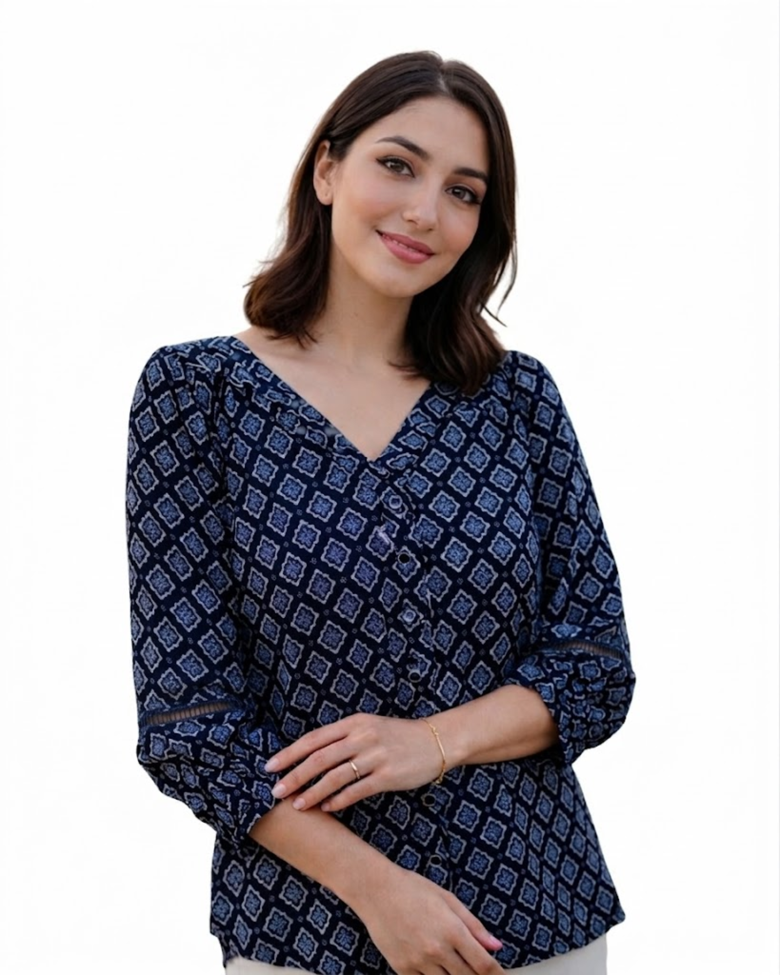 Woman wearing a navy blue patterned blouse on a white background
