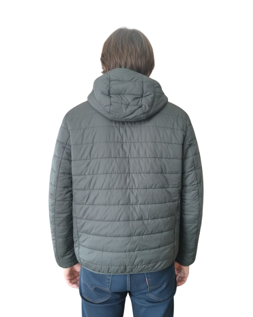 Person wearing a green quilted jacket on a white background