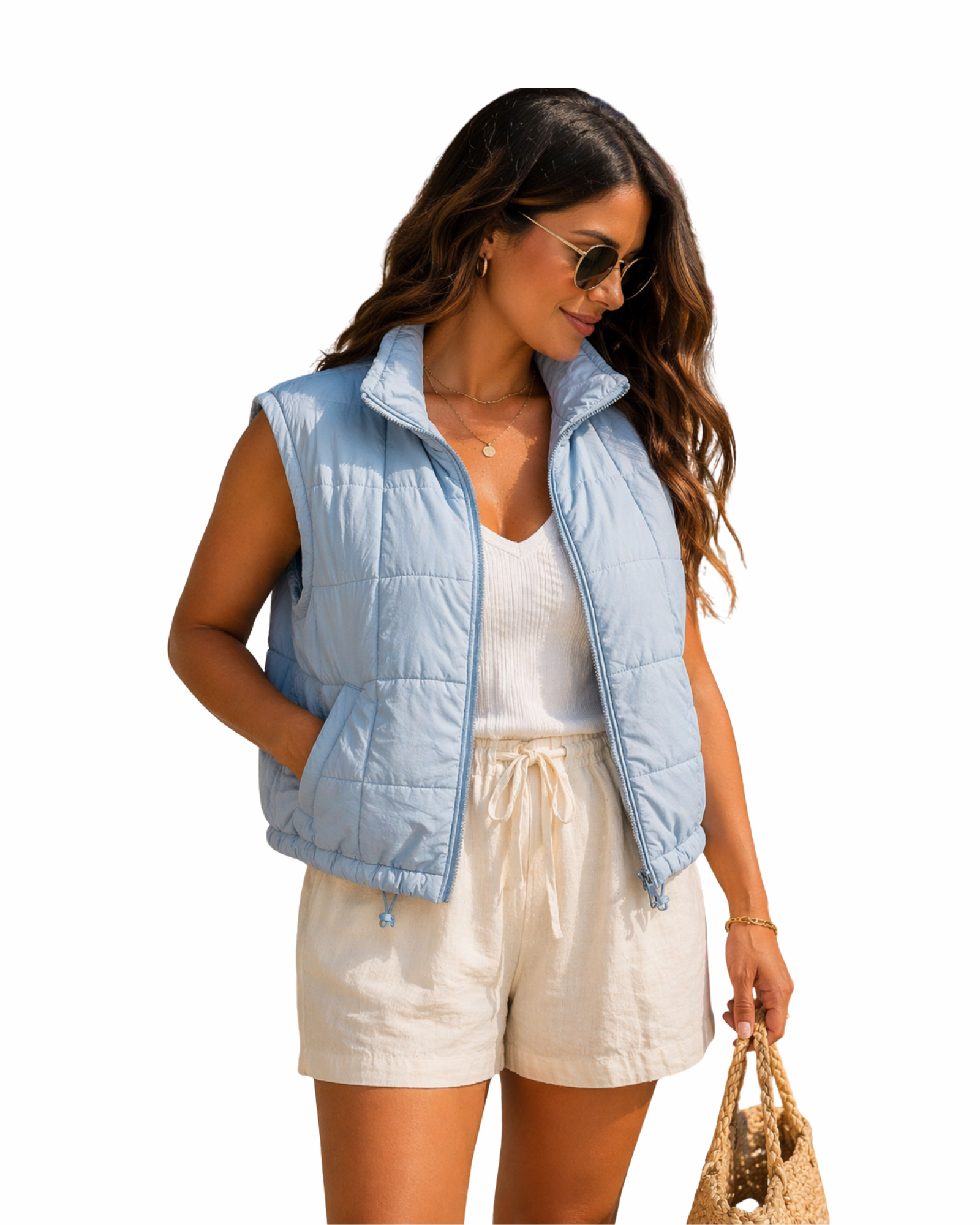 Woman wearing a light blue puffer vest over a white top and beige shorts on a white background