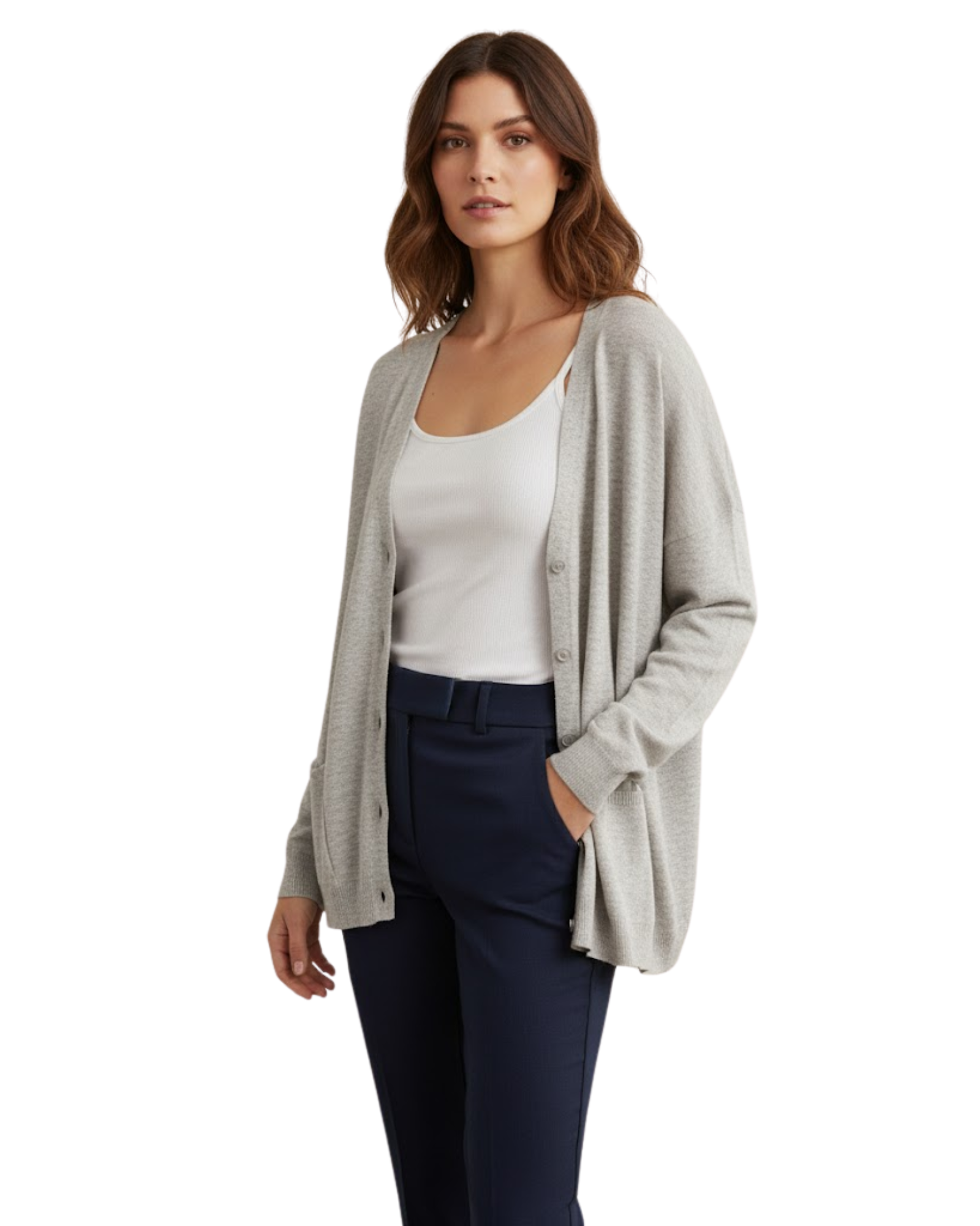 Woman wearing a light gray cardigan over a white top and dark blue pants on a white background
