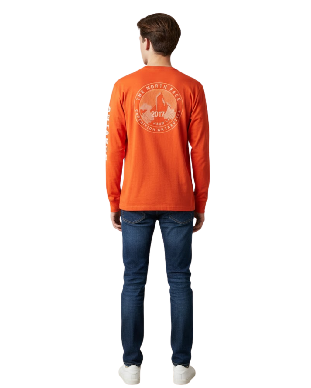 Person wearing an orange long-sleeve shirt with a logo on the back