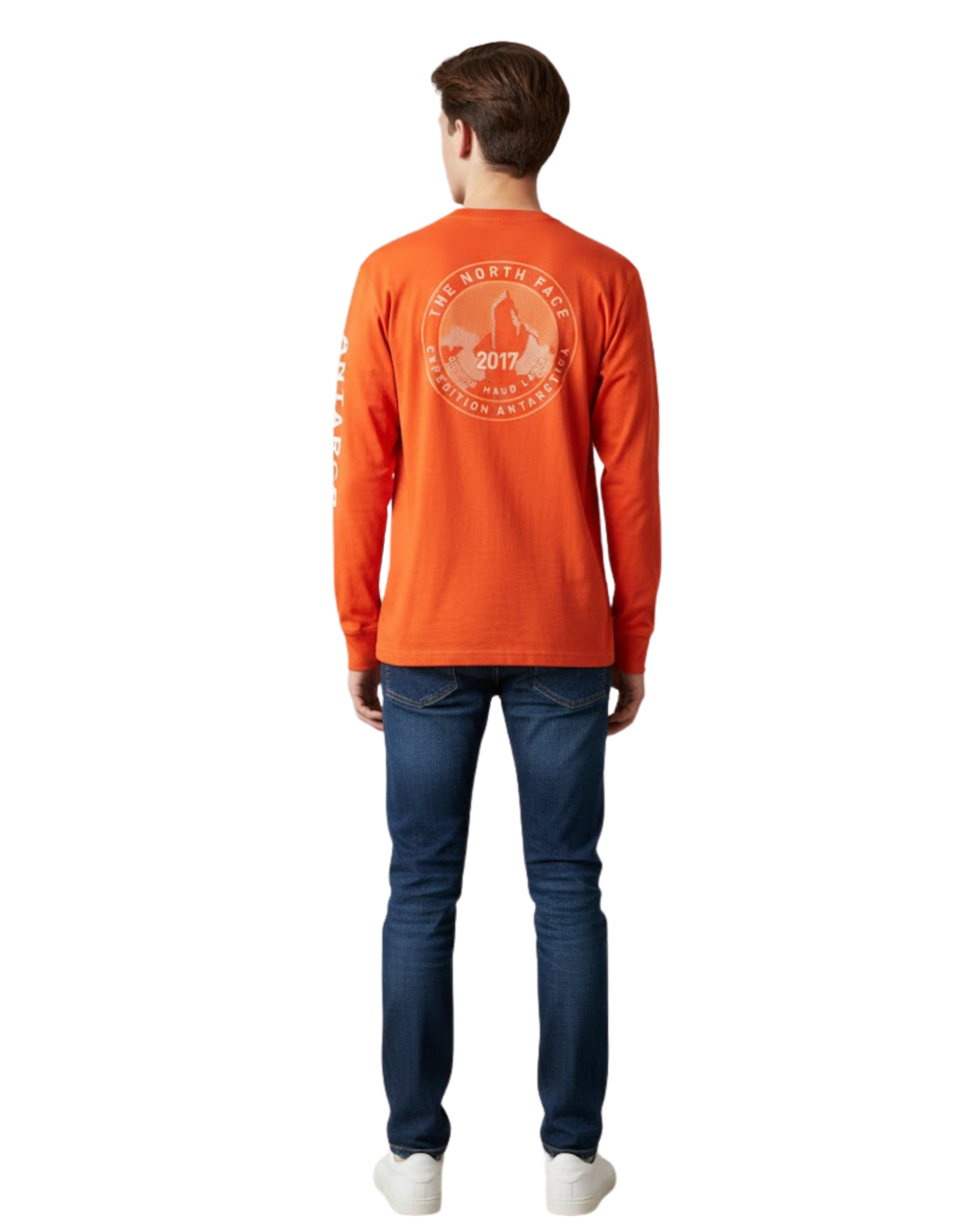 Person wearing an orange long-sleeve shirt with a logo on the back