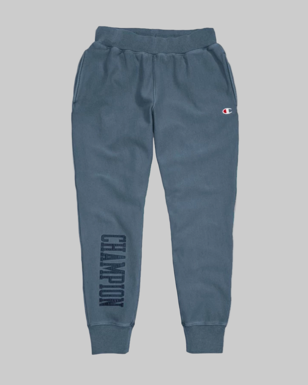 Blue sweatpants with Champion logo on a white background
