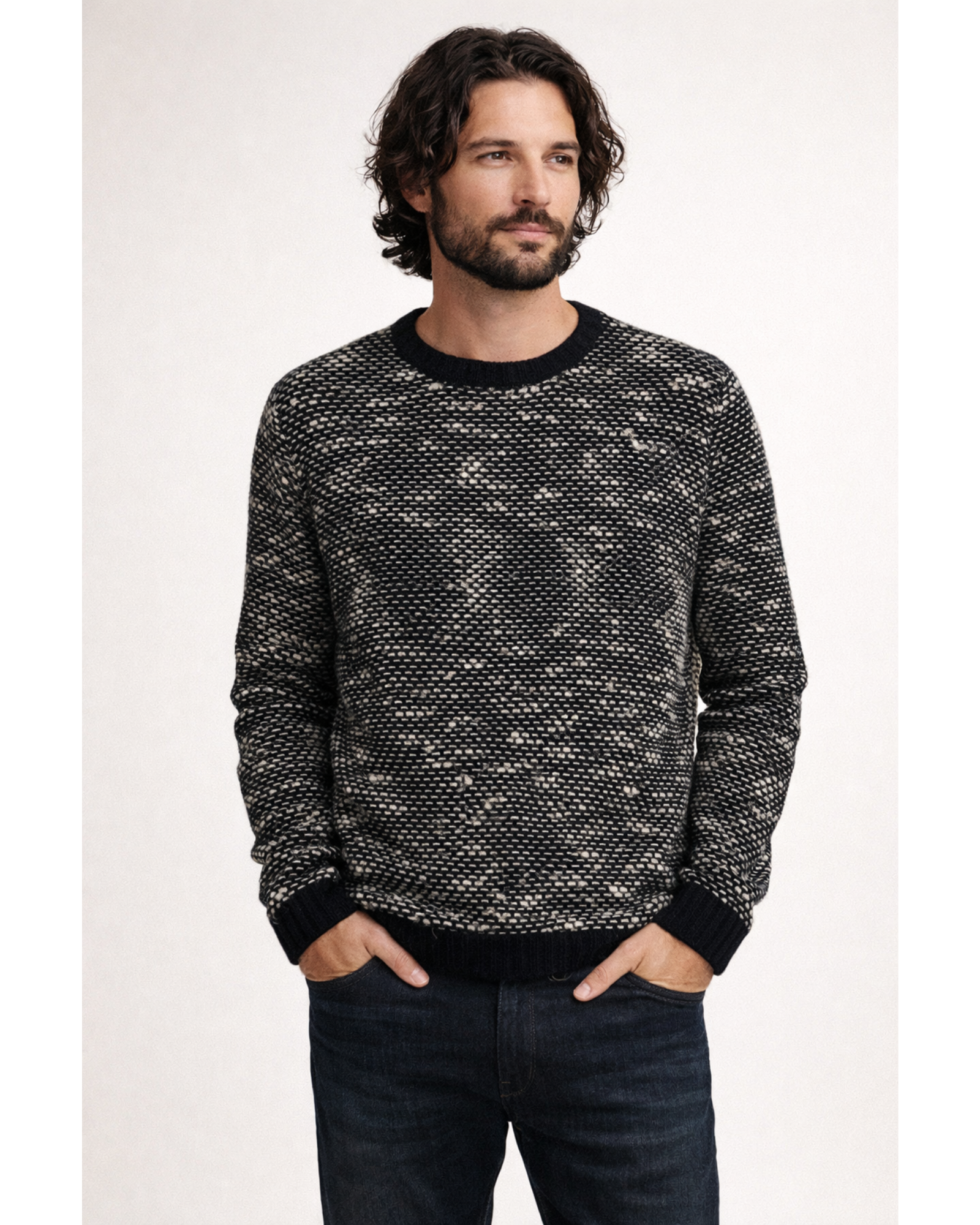 Man wearing a patterned sweater against a white background