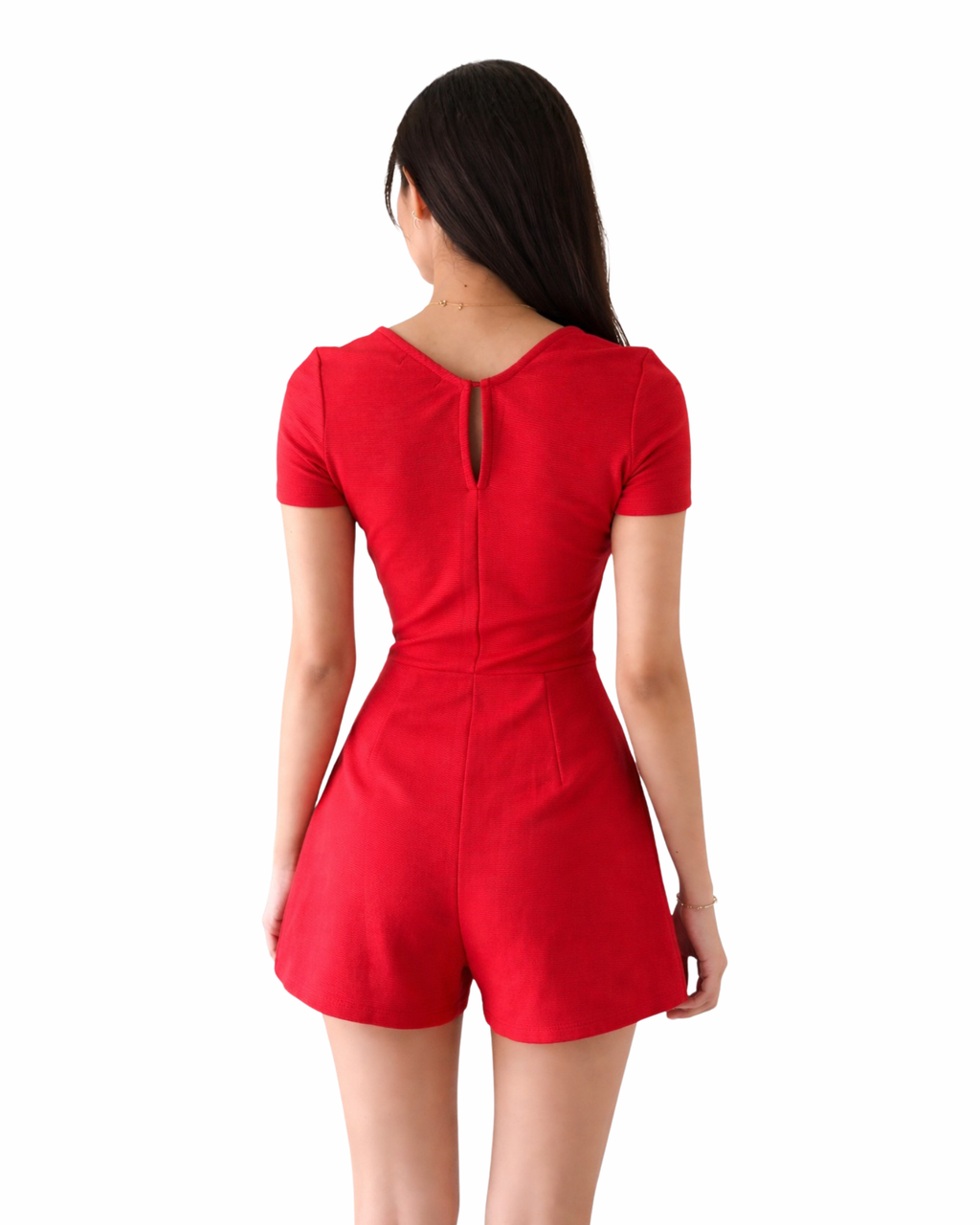 Red romper worn by a person on a white background