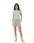 Woman wearing a light green t-shirt and floral shorts on a white background