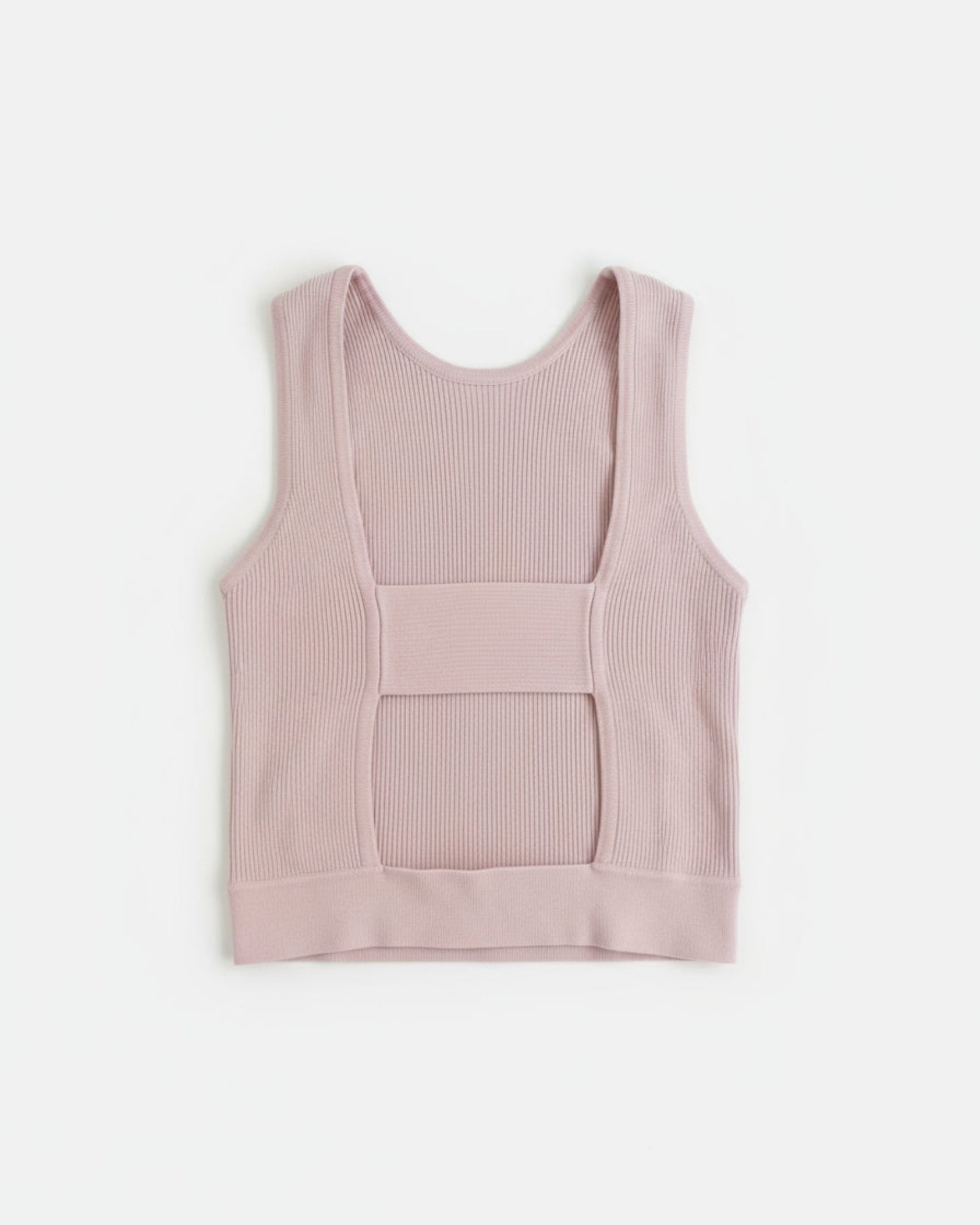 Pink ribbed tank top on a textured gray background
