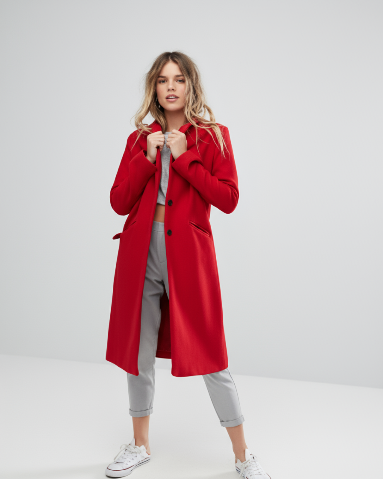 Woman wearing a red coat on a white background