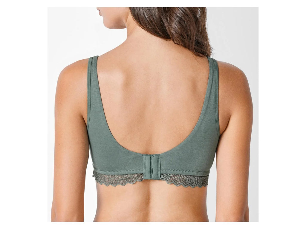 Green bralette worn by a model on a white background
