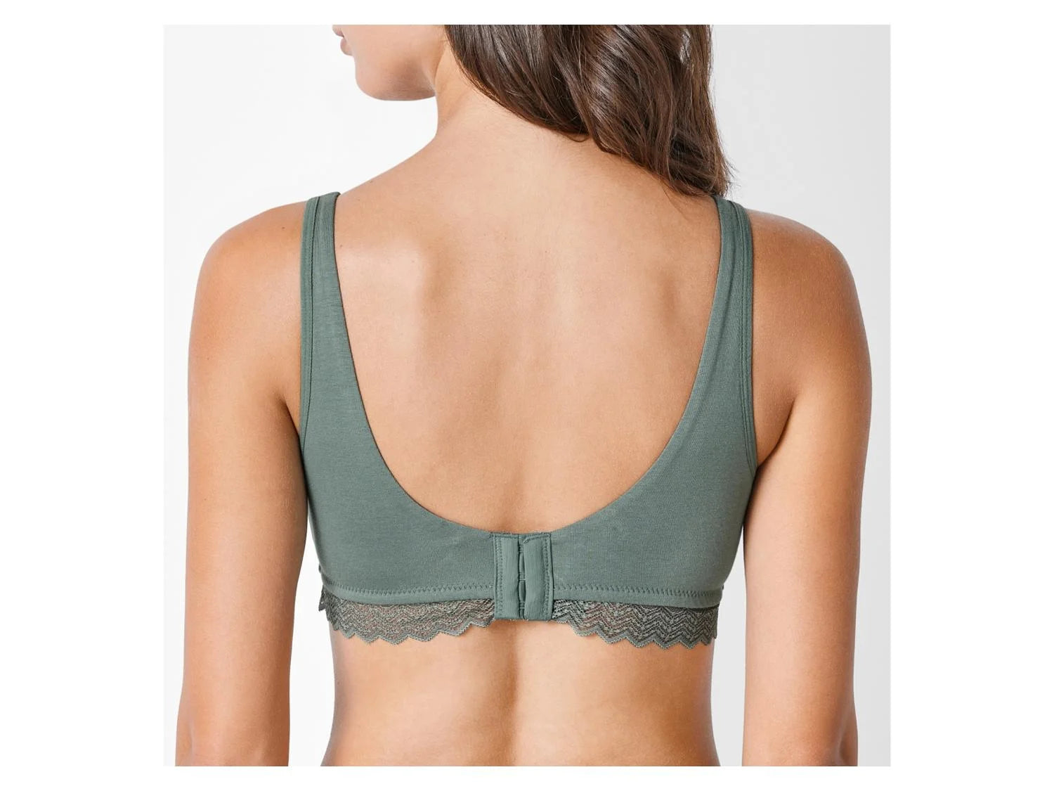 Green bralette worn by a model on a white background
