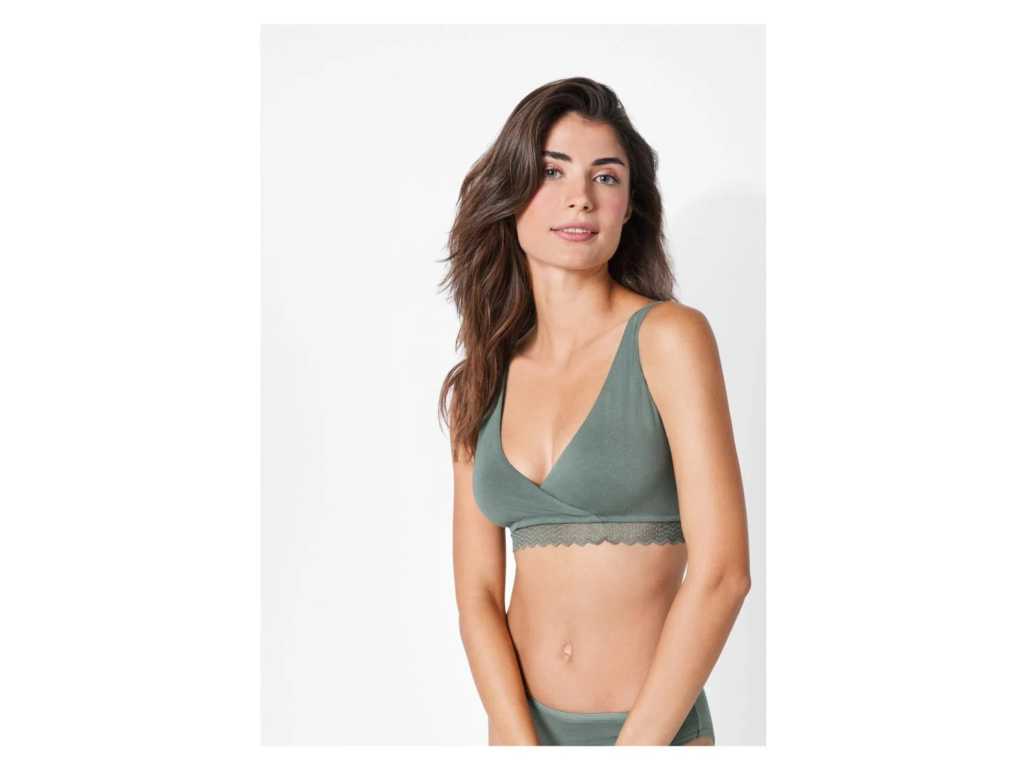 Woman wearing a green bralette on a white background