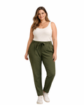 Woman wearing green pants and a white top on a white background
