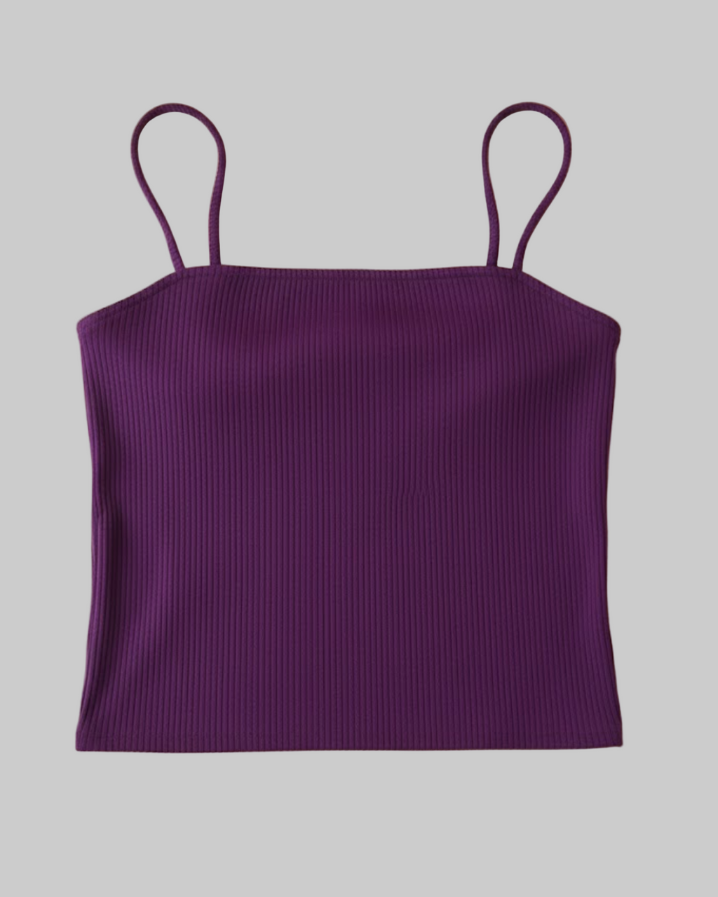 Purple ribbed tank top with thin straps on a beige background