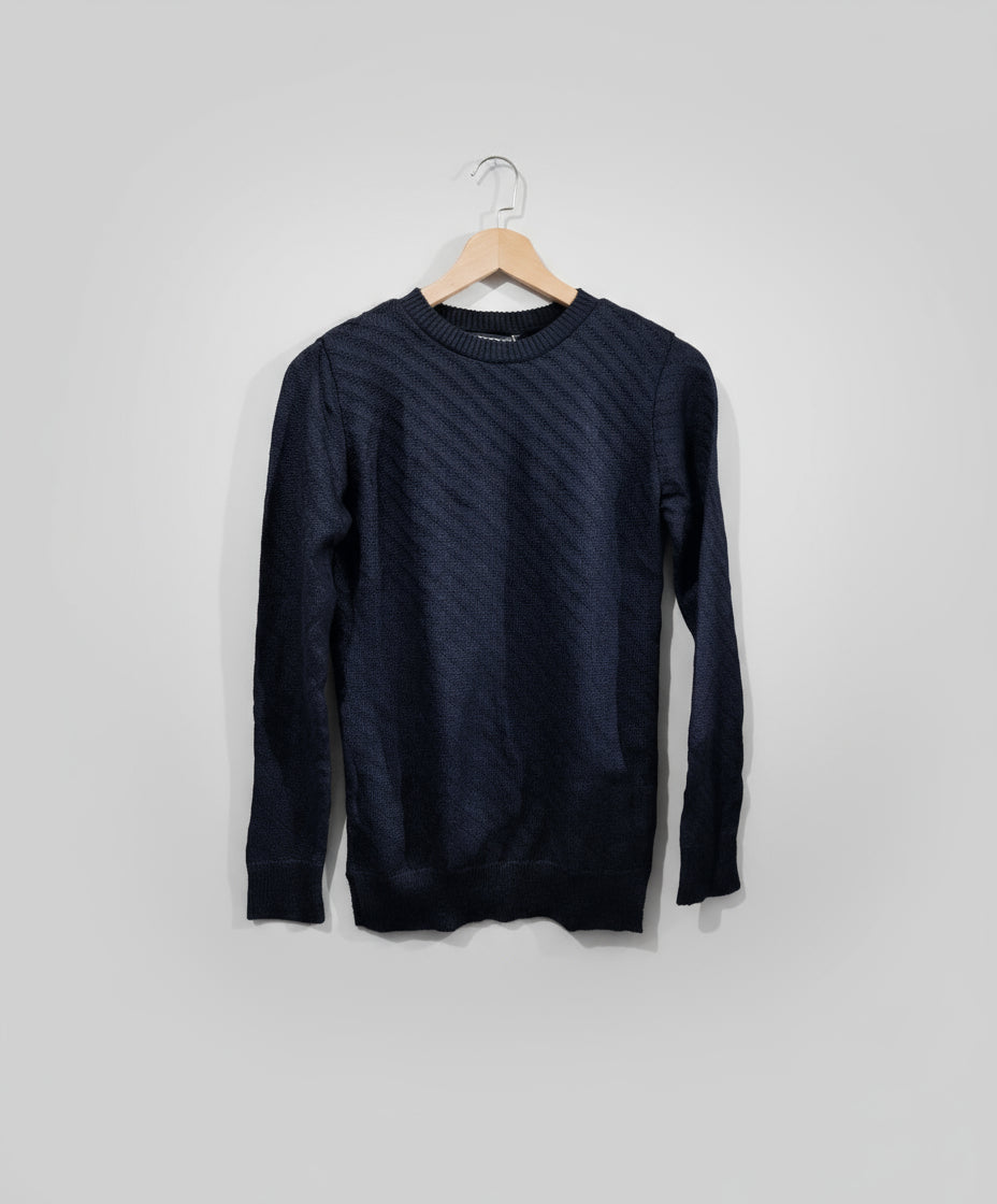Dark blue sweater on a hanger against a light gray background