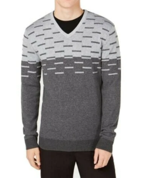 Person wearing a gray patterned sweater on a white background