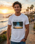 Man wearing a 'California Sunset' t-shirt on a beach at sunset