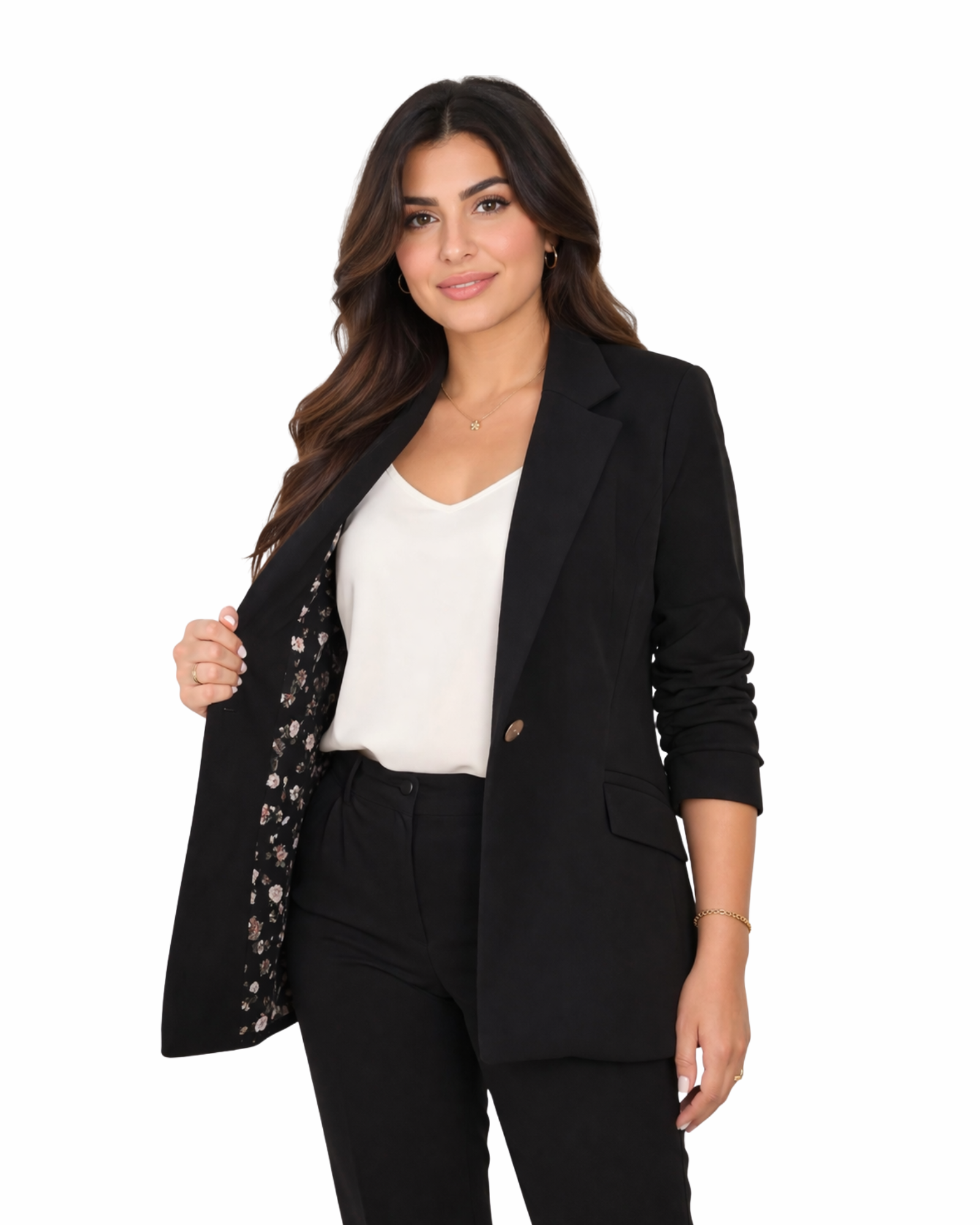Woman wearing a black blazer over a white top and black pants on a white background