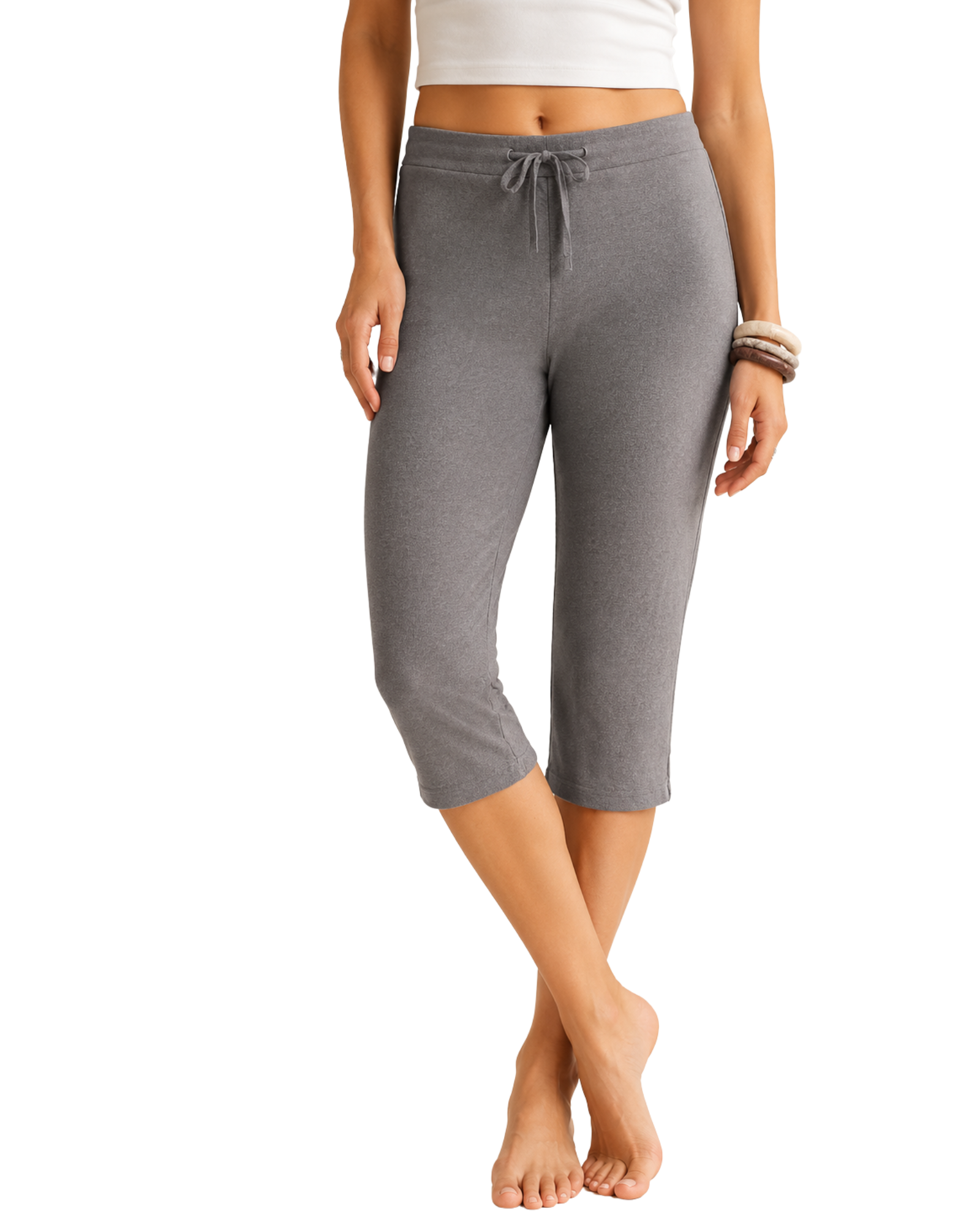 Person wearing gray capri pants on a white background