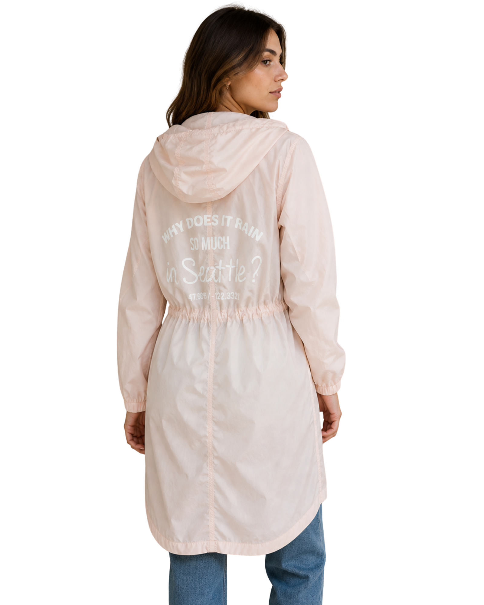 Woman wearing a light pink hooded jacket with text on the back, standing against a white background