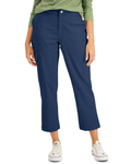 Person wearing blue pants and a green patterned top on a white background